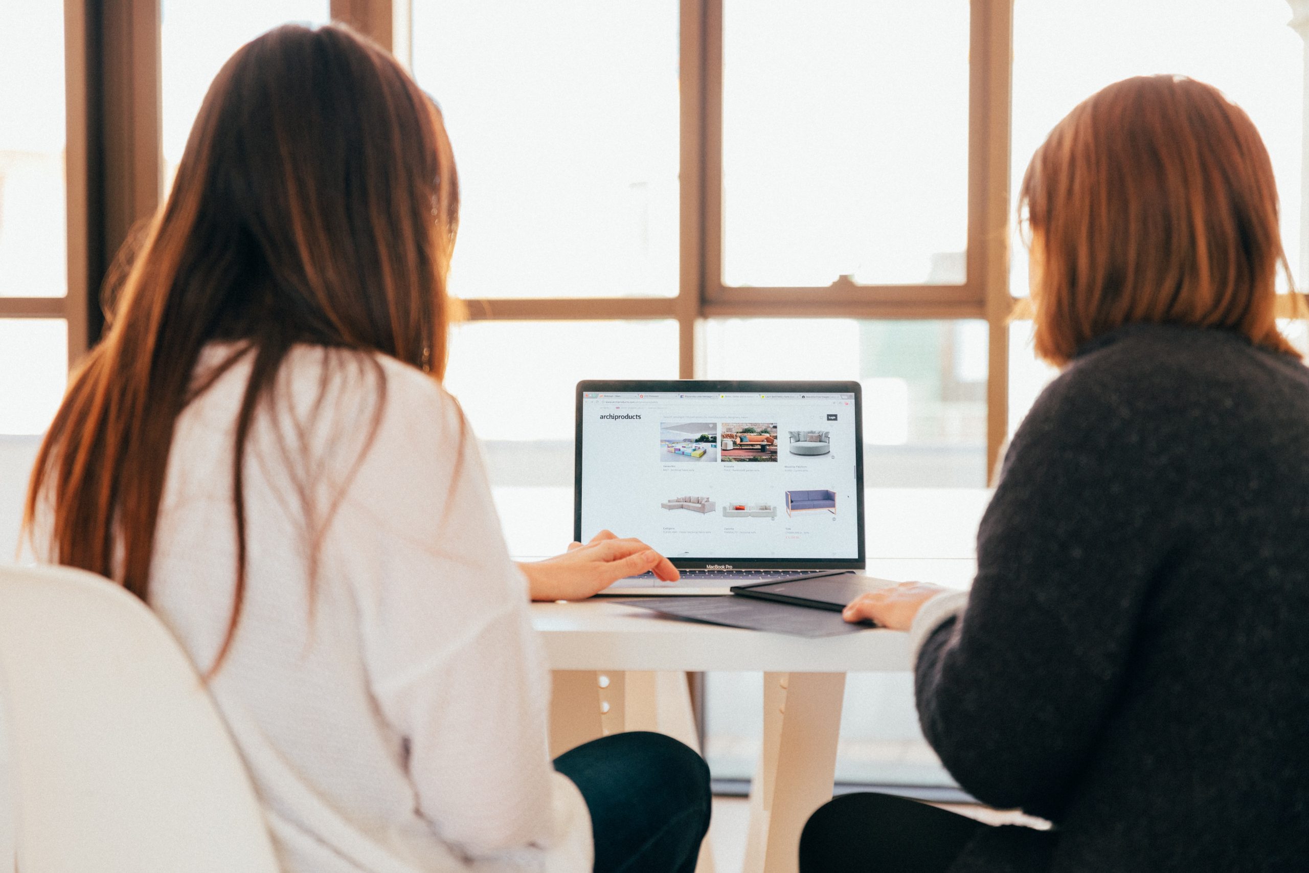 two women viewing a laptop